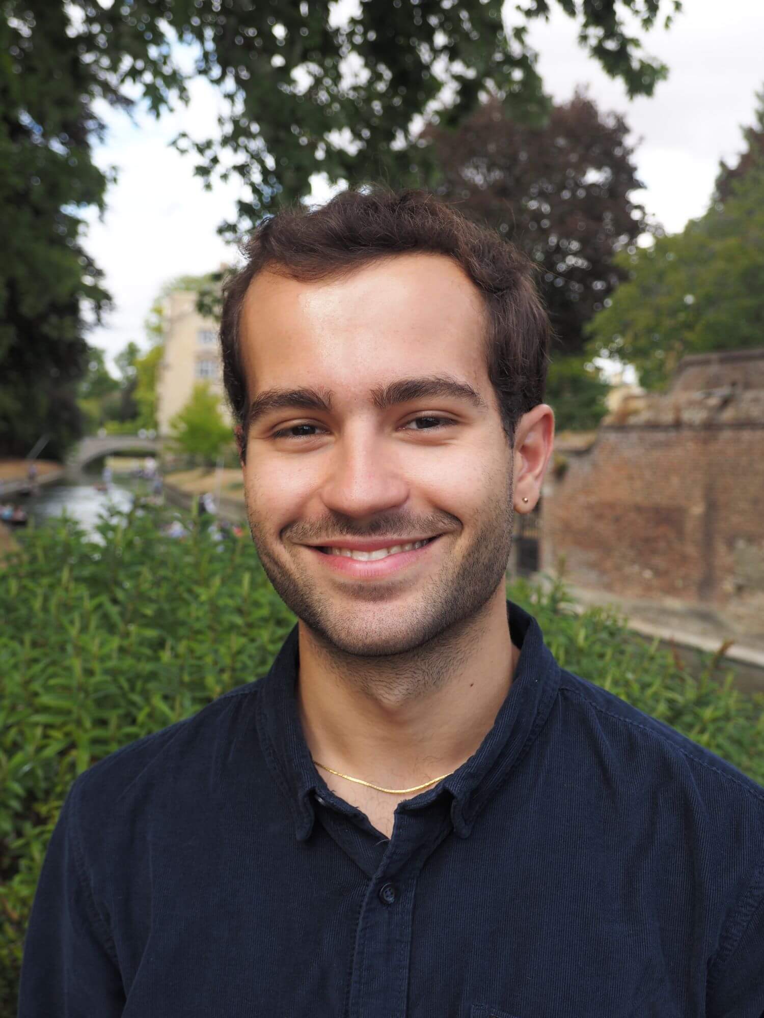 A headshot of Adrián
